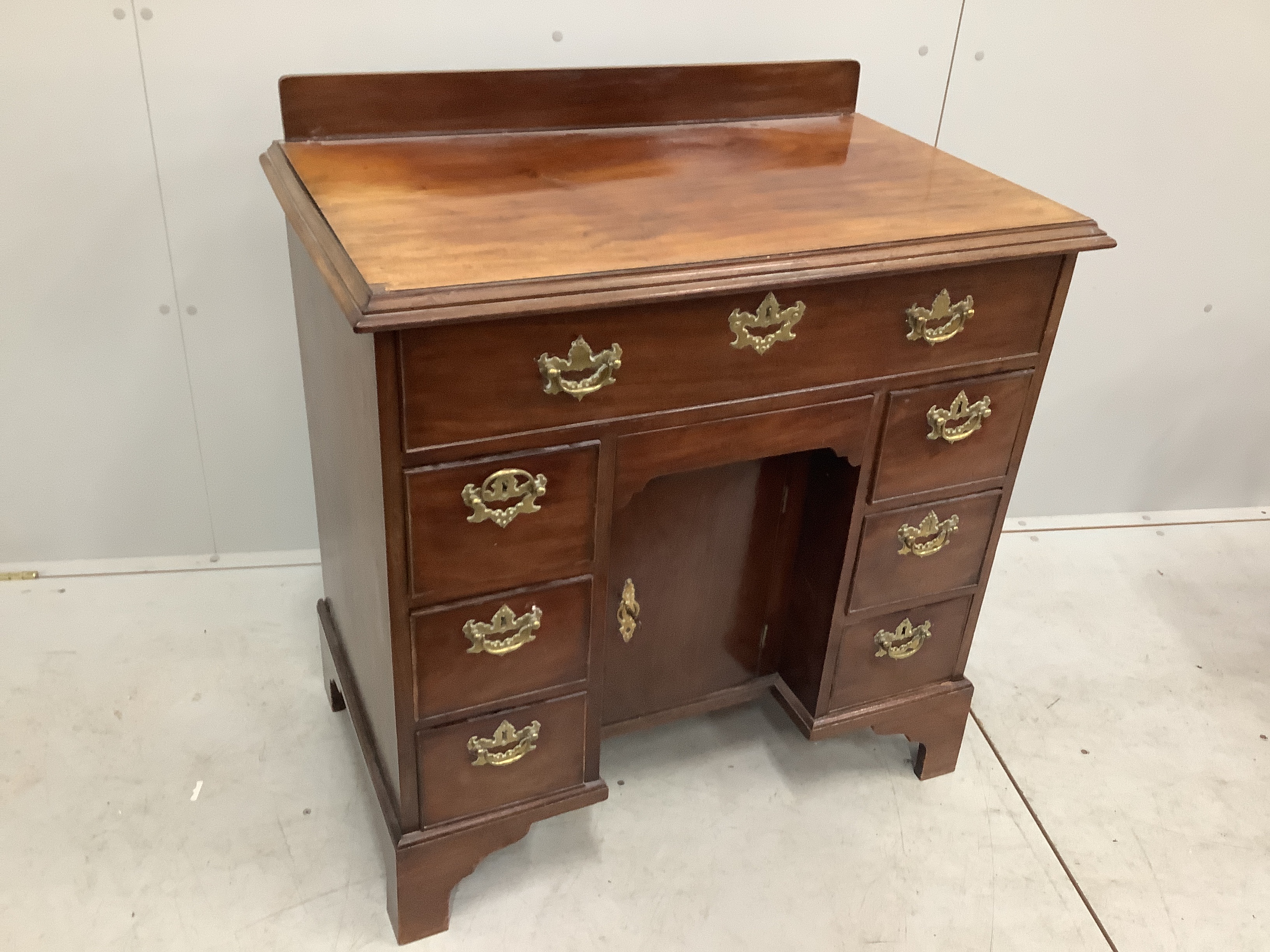 A George III and later mahogany kneehole desk with secretaire drawer, width 85cm, depth 52cm, height 92cm